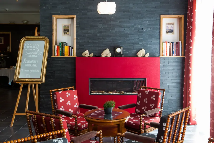 Red fireplace with upholstered chairs in the hotel lounge